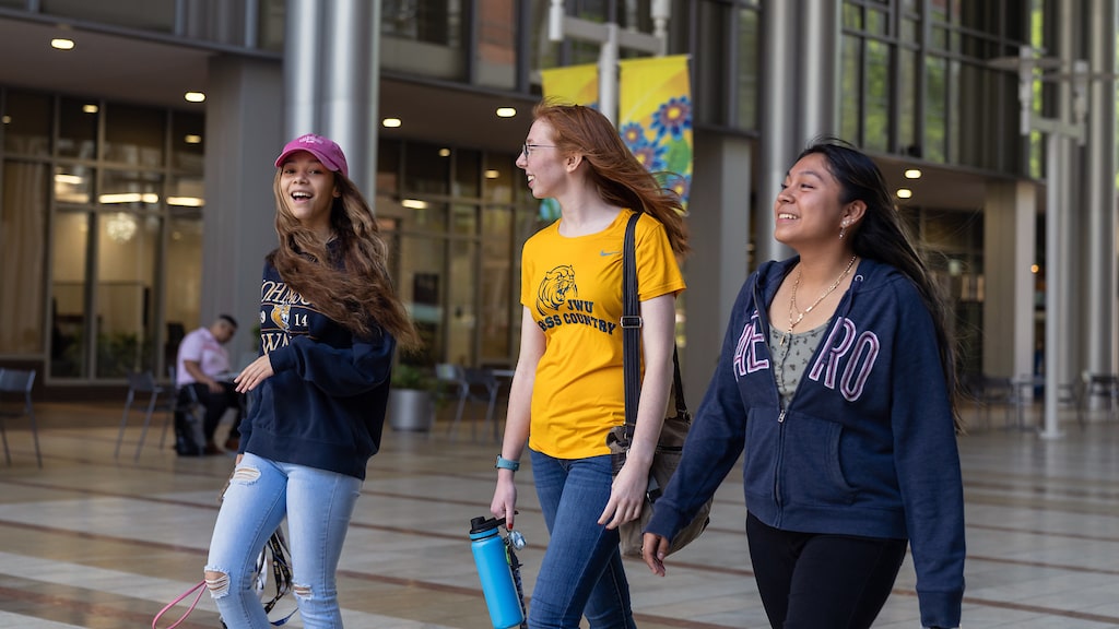 Trio of female JWU students walking together