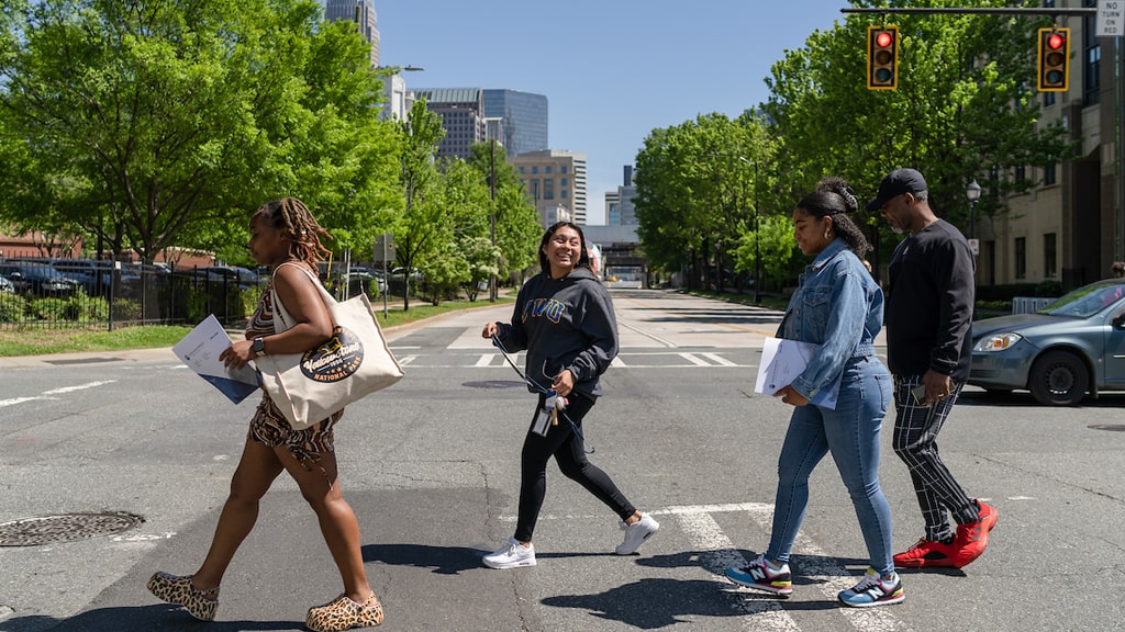 Students crossing a street near the Charlotte Campus.